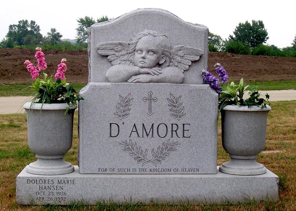 Grey granite memorial with carved cherub